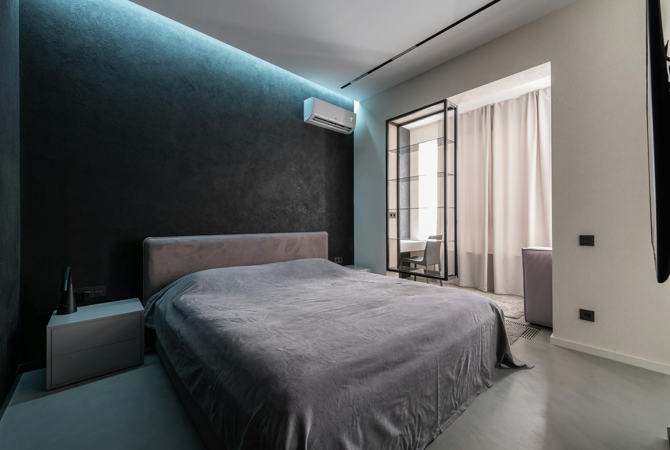 Luxury bedroom with a discreet wall mounted air conditioning unit